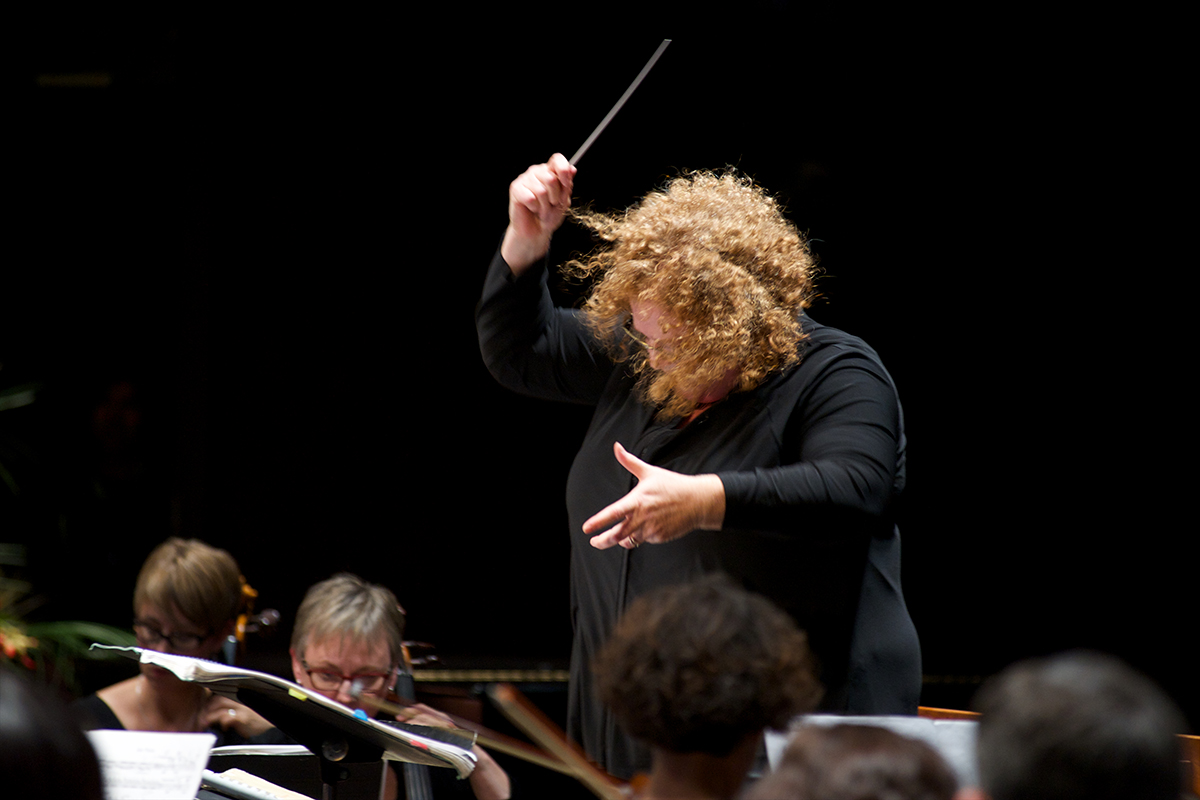 Rosemary Thomson conducting on a podium