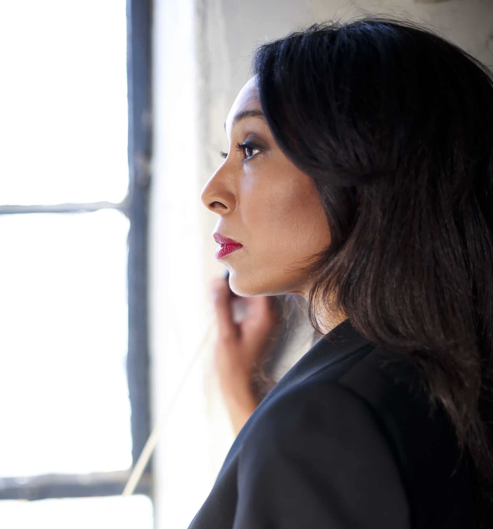 Jeri Johnson looking out window in profile