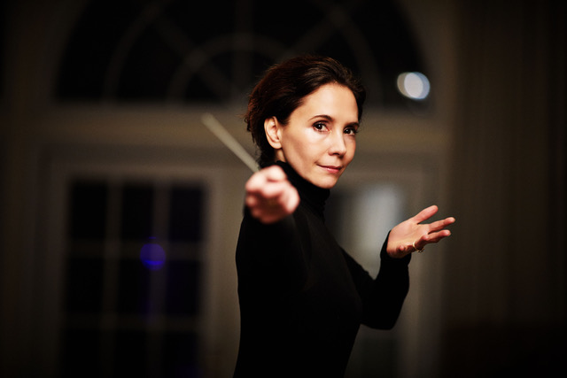 Sarah Ioannides holding a conductor's baton