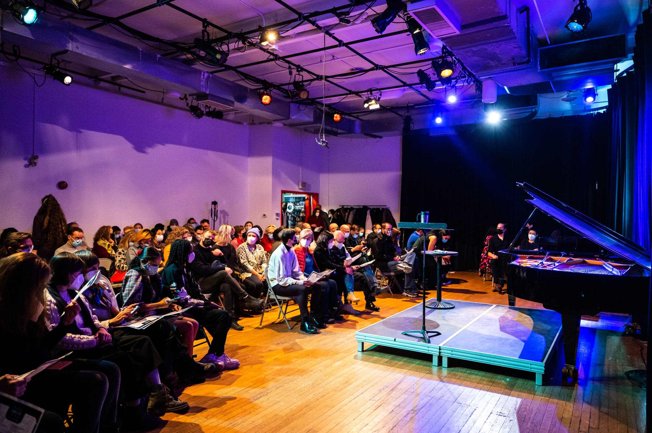 A colour photo of audience members sat in a studio